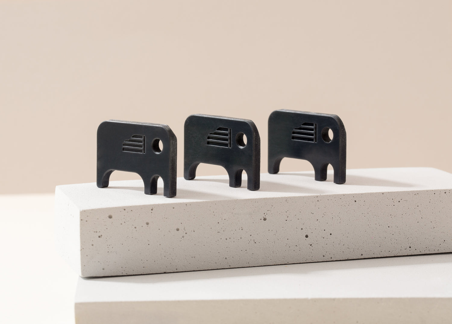 Pianosmiths Down bearing Elephant Keyrings Displayed on Concrete